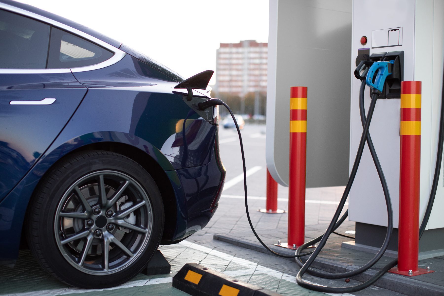 An electric car charging at a public charging station